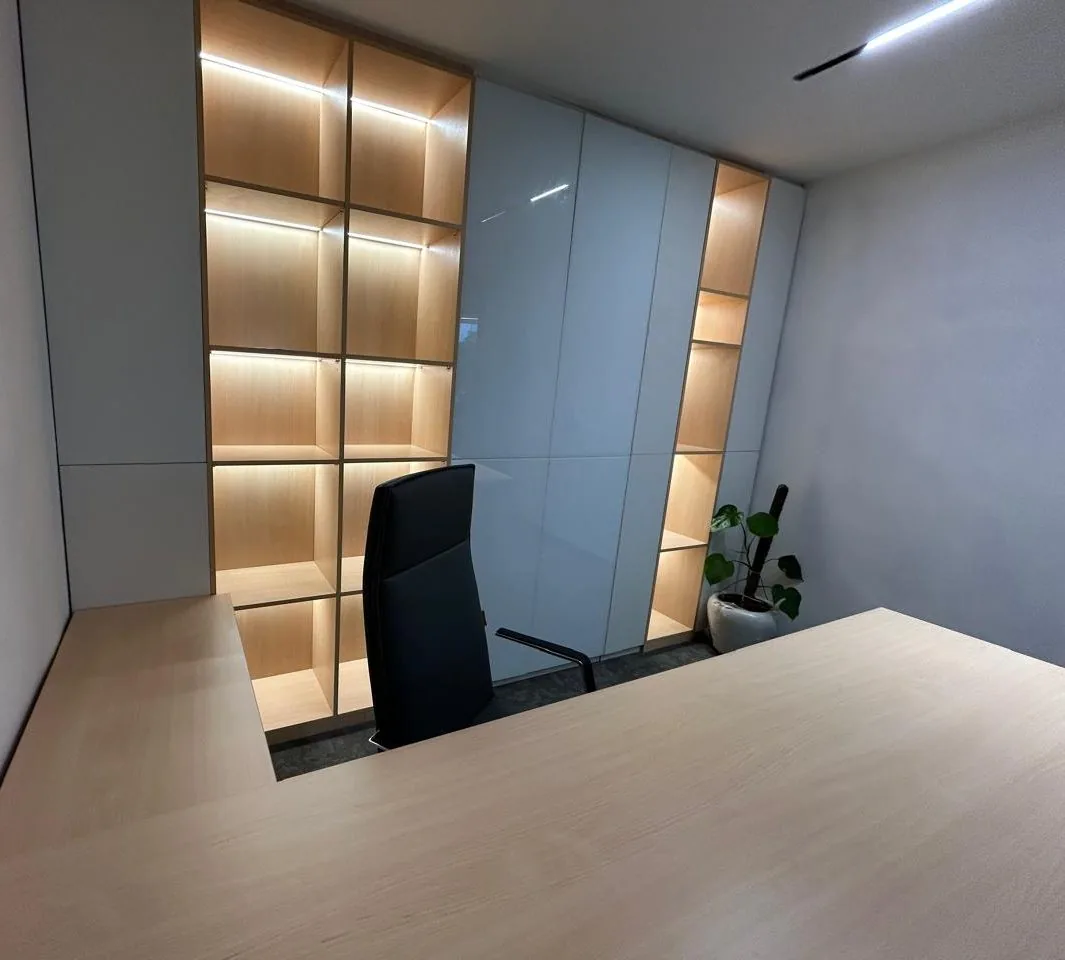 Executive cabin with backlit shelving, built-in storage and a large desk